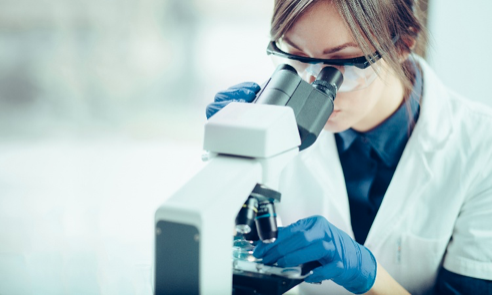 Person looking through a microscope
