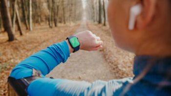Female runner checking smartwatch while running|Loving her morning workouts