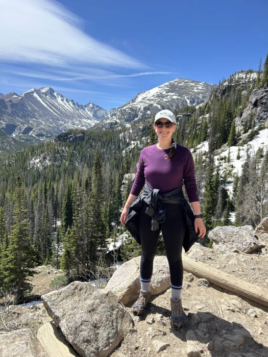 A lady with mountains in the skyline